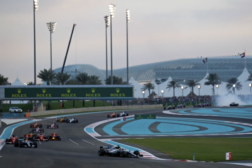 Valtteri Bottas leads the field in his Mercedes with a wide shot of the track in the background