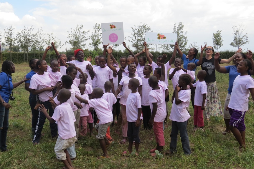 Children cheering with Sarah Rosborg
