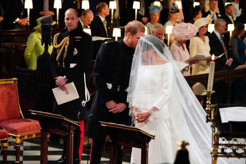 Prince Harry whispers to Meghan Markle at the beginning of the ceremony.