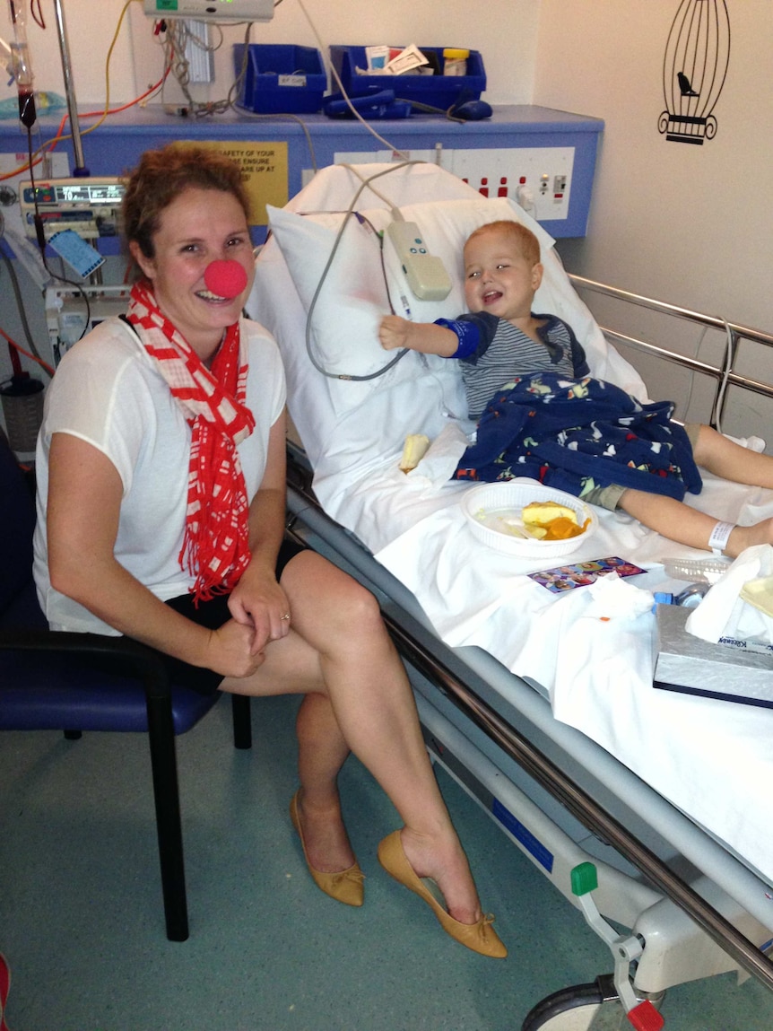 Danielle Kelly wearing a red nose by her son's hospital bed.