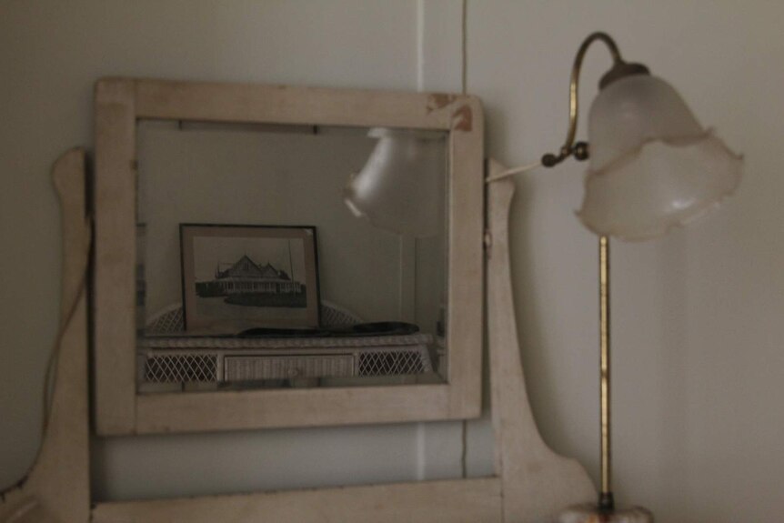 The reflection of an antique house design in an antique mirror.