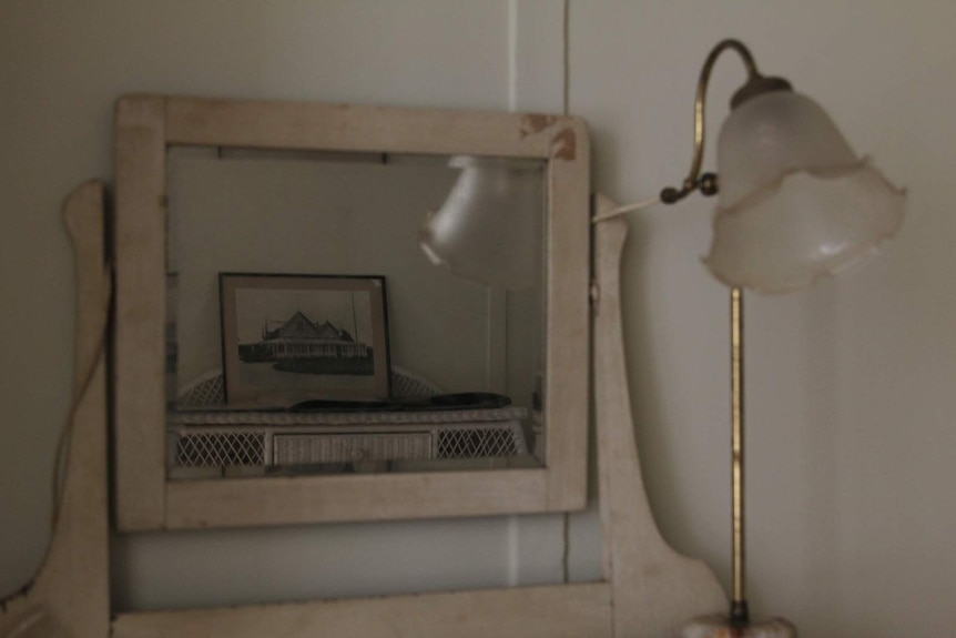 The reflection of an antique house design in an antique mirror.