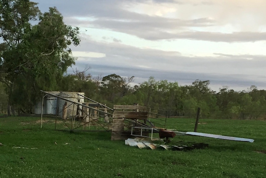 fallen windmill in lush green field