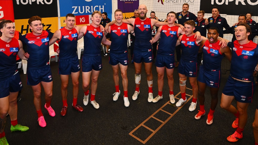 The Melbourne Demons celebrate after a win in 2023.