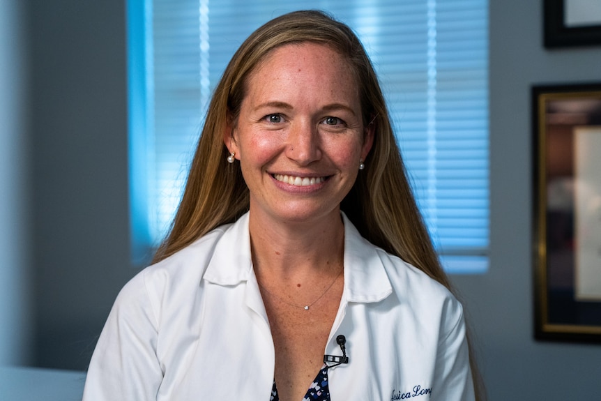 A photo of Dr Long in front.  She has long blonde hair and a broad smile. 