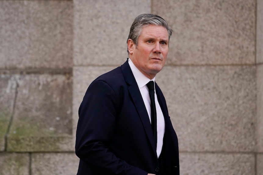 Britain's Labour Party leader Heir Starmer walks outside a church