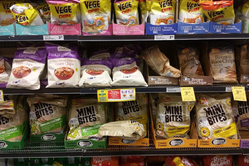 Packets of colourful chips line supermarket shelves.