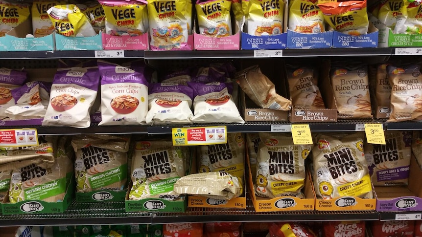 Packets of colourful chips line supermarket shelves