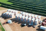 a birds-eye-view of large rectangular boxes connected to a solar panel grid.