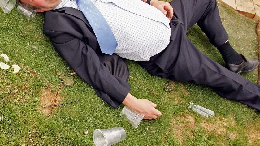 A male race-goer passes out after one too many drinks