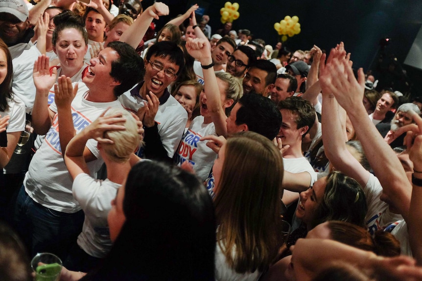 Labor volunteers celebrate after being mentioned in Kevin Rudd's speech.
