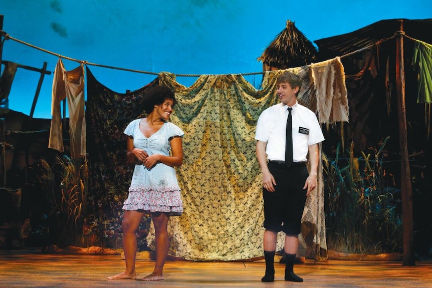 Nabulungi and Elder Cunningham on stage in The Book of Mormon