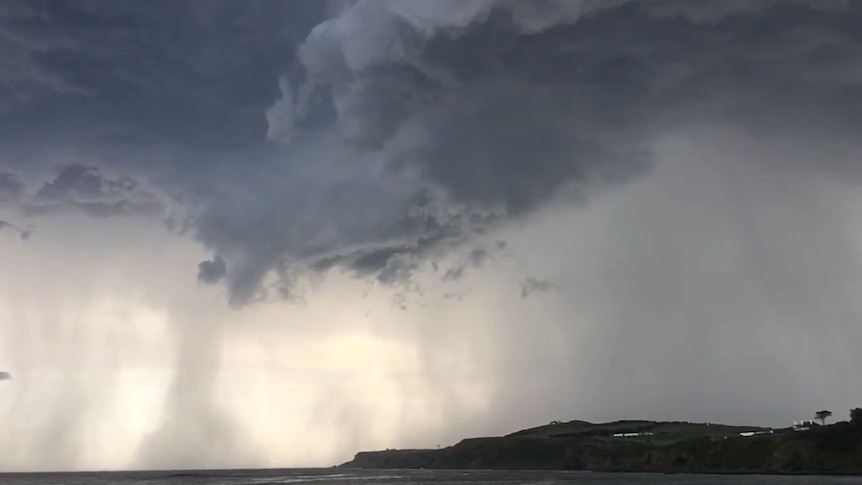 Dramatic storm clouds over ocean in Flinders in Victoria land peninsula in bottom right-hand side
