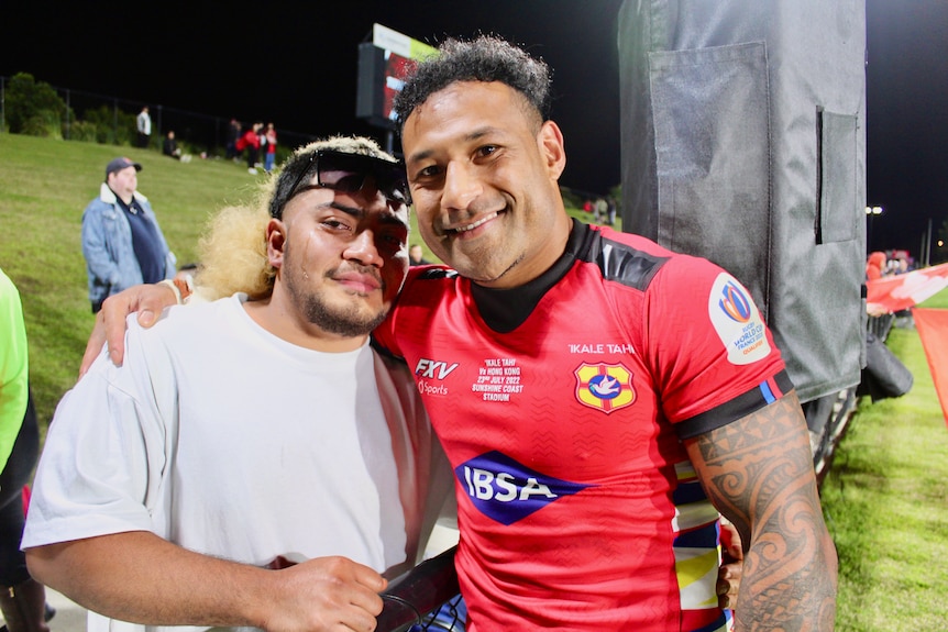 Tonga rugby union captain Sonatane Takulua embraces a fan after beating Hong Kong at Sunshine Coast Stadium.