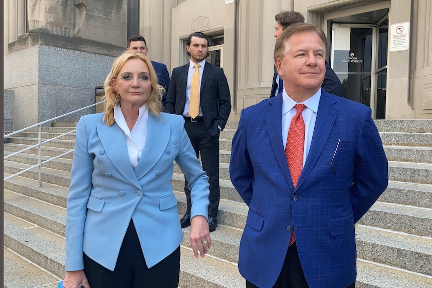 Patricia McCloskey looks at the camera with Mark McCloskey next to her on the steps of the court.