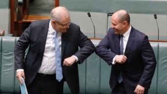 Scott Morrison and Josh Frydenberg elbow-bump in the House of Representatives