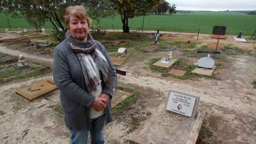June Galbraith stands beside the grave of her dog Grizzles