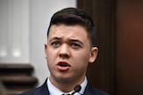 Young man in a suit testifying in court. 