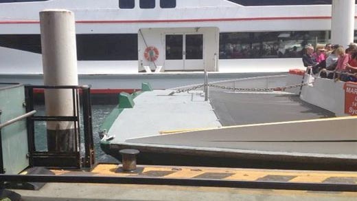 Sydney ferry passengers look at damage to the front of the vessel