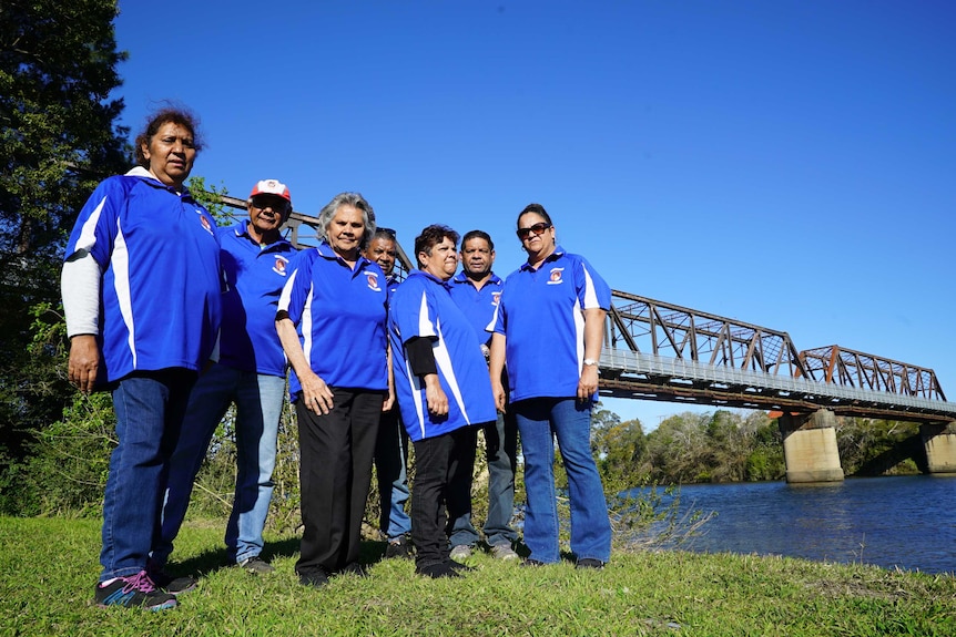 Buddy's family gather beneath the rail bridge near where his body was found in 1983.