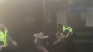 A still of video footage showing Protective Services Officers allegedly attacking man on the platform at Merri train station.