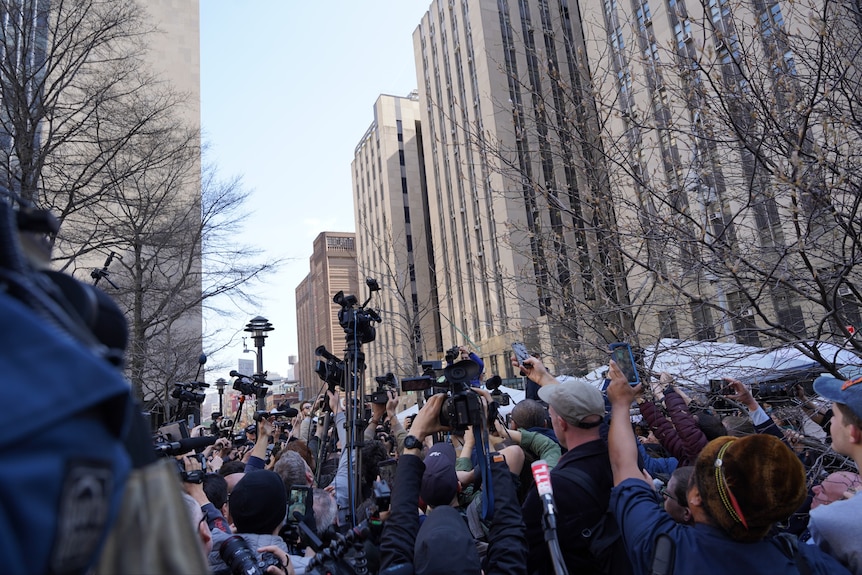 Crowds wait for the arrivals of former president Donald Trump ahead of his indictment. 