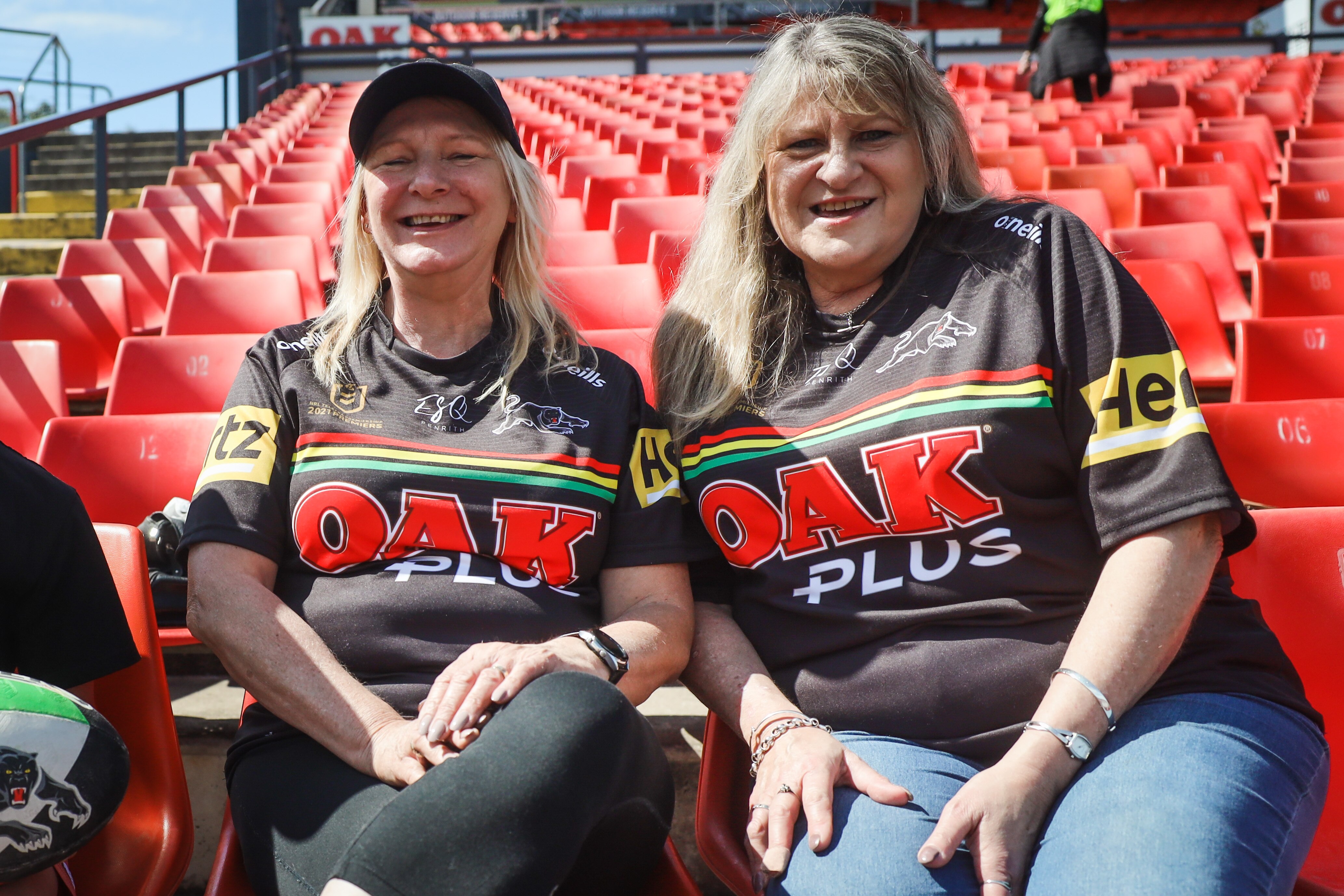 Two women smiling in stadium 