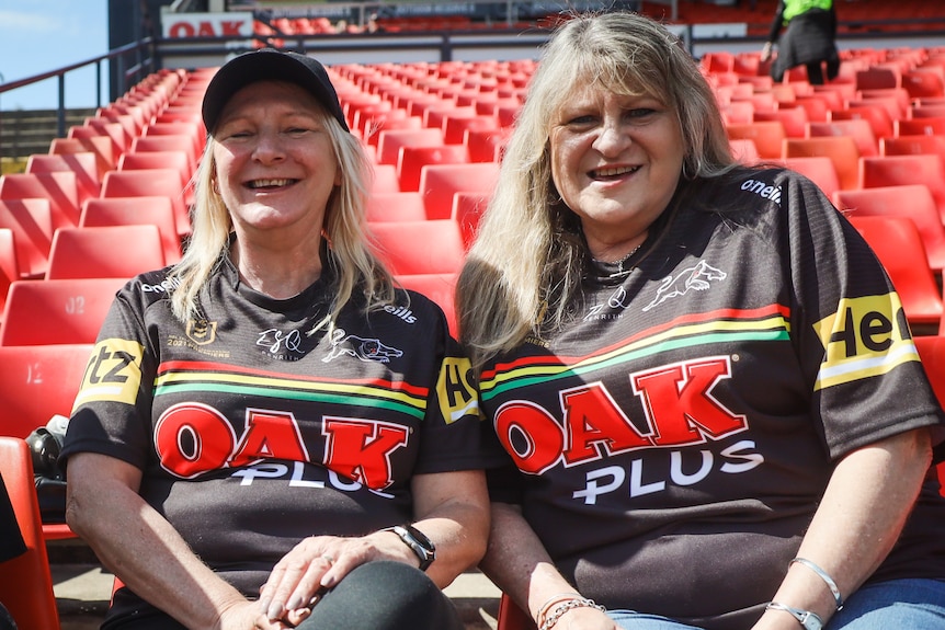 Two women smiling in stadium 