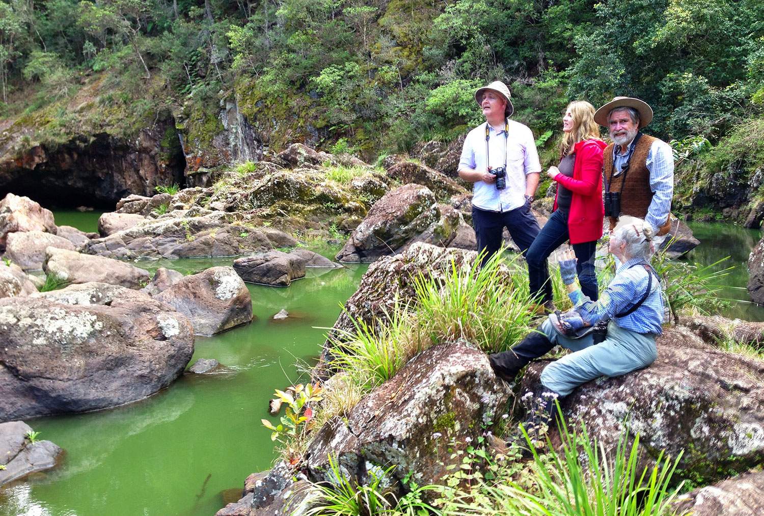 Three Sunshine Coast environmentalists stand on rocks at the bottom of Obi Obi Gorge