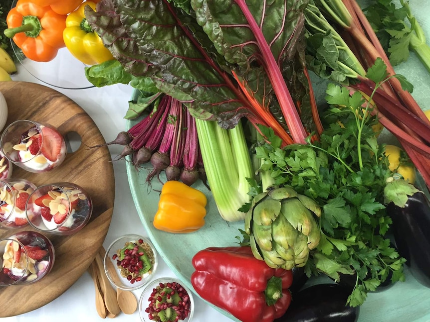 A table of healthy food, including fruit, vegetables and healthy snacks, recommended by the Cancer Council.