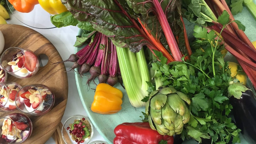 A table of healthy food, including fruit, vegetables and healthy snacks.