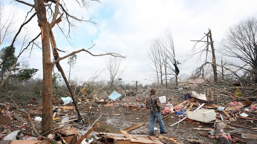 Blake Martin searches through the debris of his home