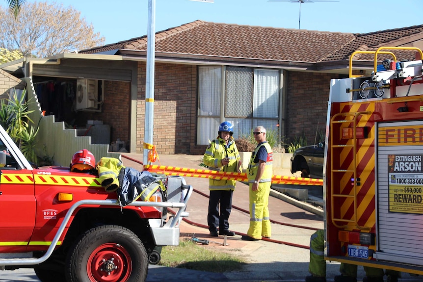 Firefighters with their appliances outside a home in Kingsley where a man died in a shed fire.
