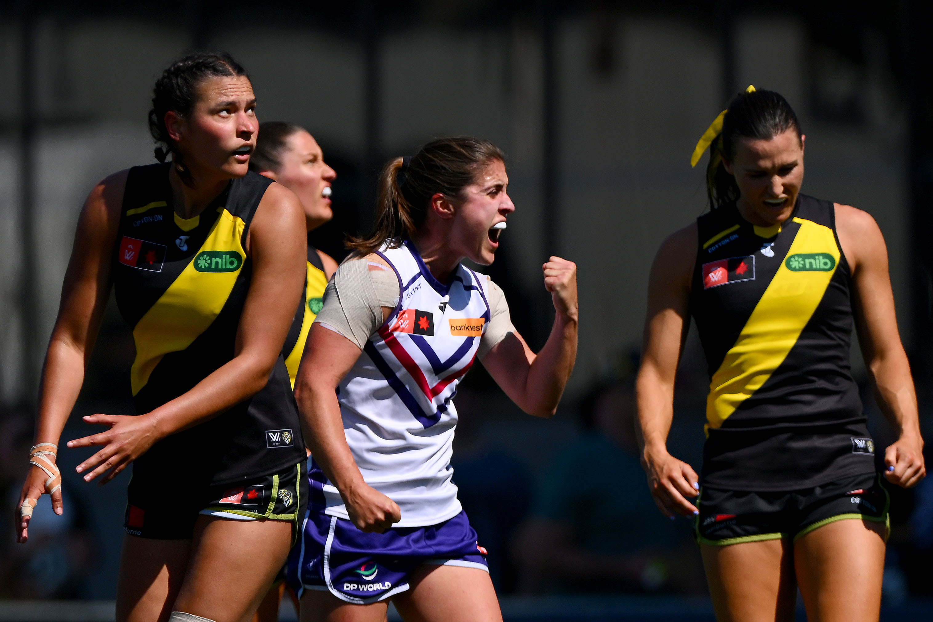 Gabby O'Sullivan pumps her fist in delight as Richmond players look disappointed