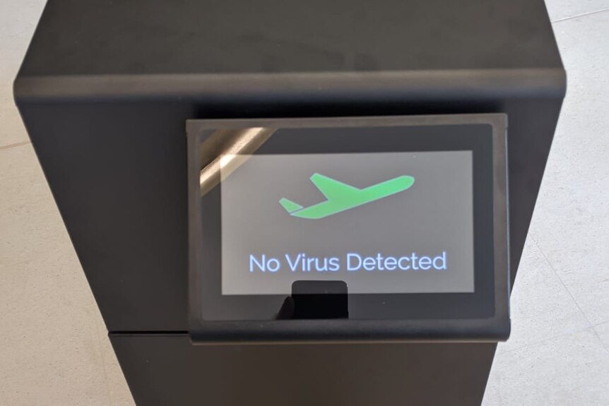 A black rectangular machine with a screen that reads "No virus detected".