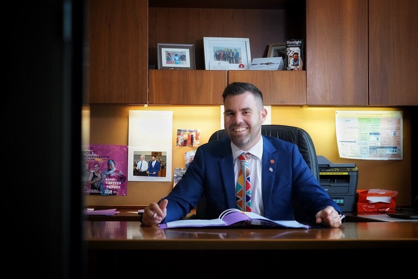 Chansey Paech sits at his desk in Darwin.