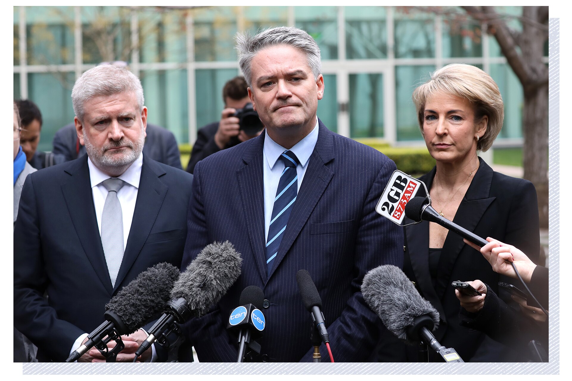 Three people in front of microphones.