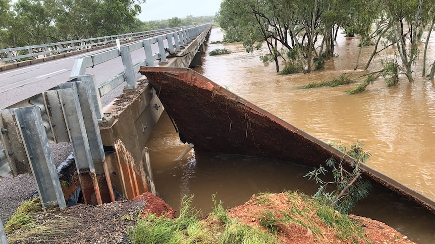 A chunk of debris washed up next to a bridge in floodwater