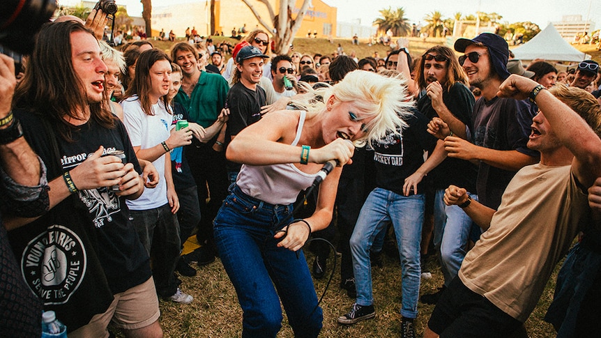 Amyl & the Sniffers lead singer Amy Taylor sings while in the mosh pit at Wollongong's Farmer and the Owl festival