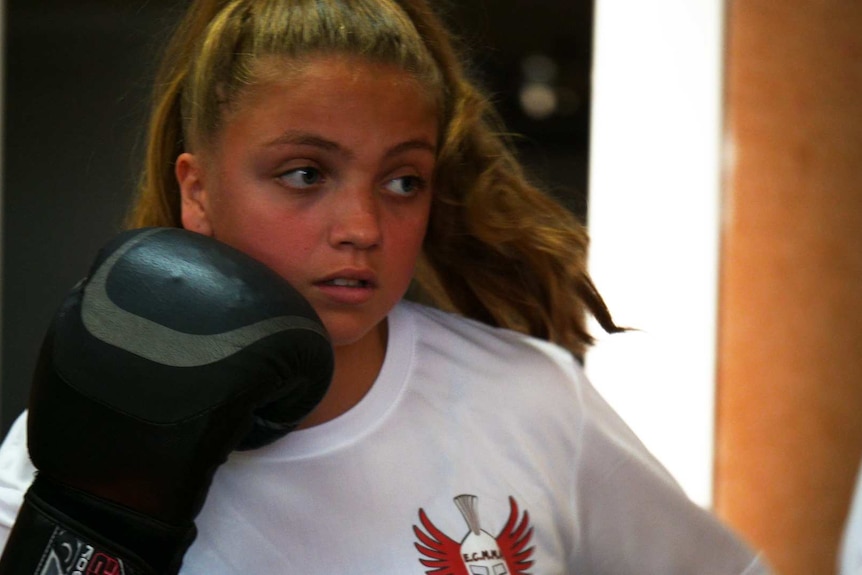 A teenage girl shows her boxing skills