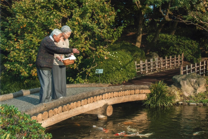 Emperor Akihito and Empress Michiko feed carp in the garden of the Imperial Residence.