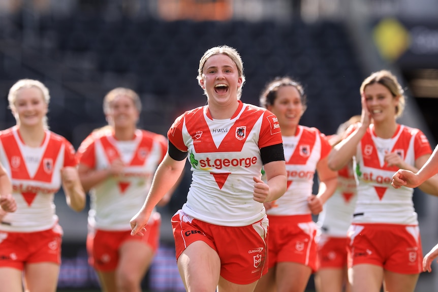 St George Illawarra Dragons NRLW players celebrate defeating Wests Tigers.