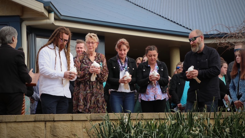 Relatives of Shyanne-Lee Tatnell hold doves