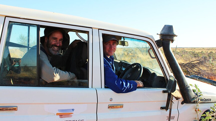 Grant Irving and Matt Warr sitting in their 4WD, smiling at the camera.