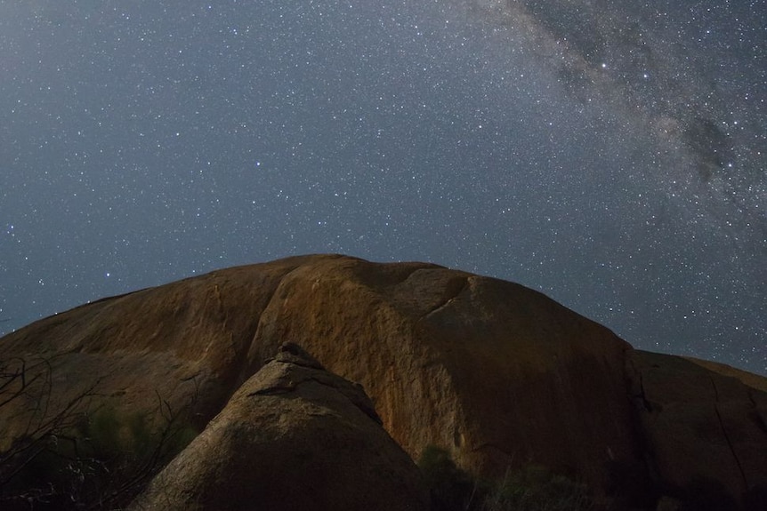 The Milky Way and the stars above a large rocky hill called Mount Hope in Central Victoria.