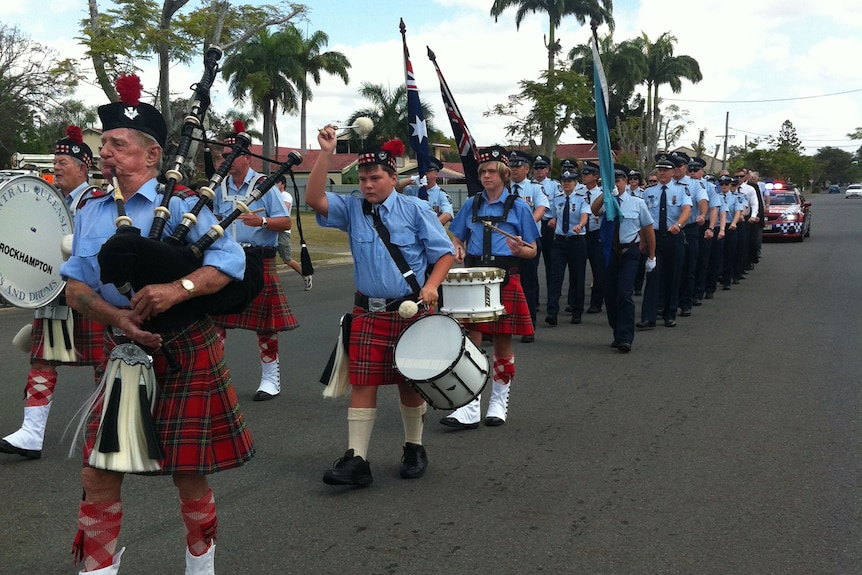Police officers march from Central Park to St Joseph's Cathedral in Rockhampton for a Police Remembrance Day service