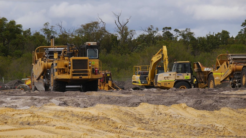 Earth moving vehicles at work on a construction site.