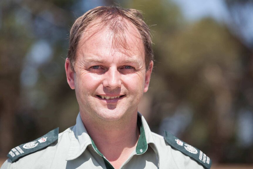 Chris Eagle, Chief Fire Officer for Forest Fire Management smiles as he looks at the camera