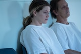 Genevieve (played by Harriet Dyer) wears a medical gown and looks distant in ABC's drama Wakefield and the myths it tackles.l. 