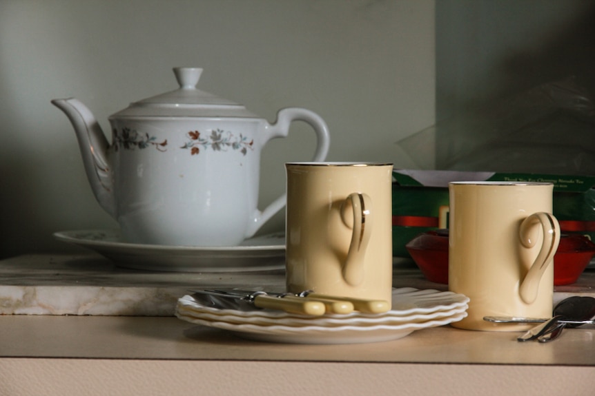 A teapot and cup and saucers in a farm house